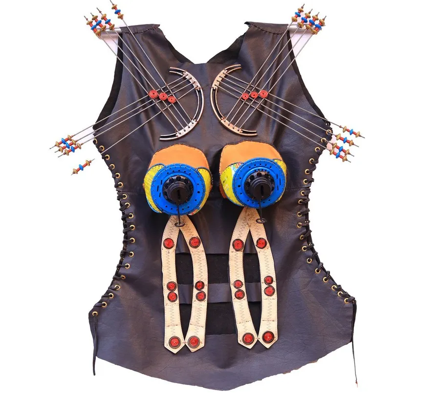 A dark leather bodice on a hanger, two blue discs at the chest, beaded red and blue spikes fanning from each shoulder