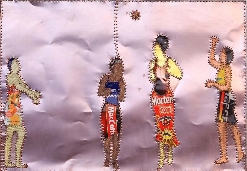 Four small figures spread across a sheet of creased pale pink paper, each built from cut tin labels and outlined in stitching