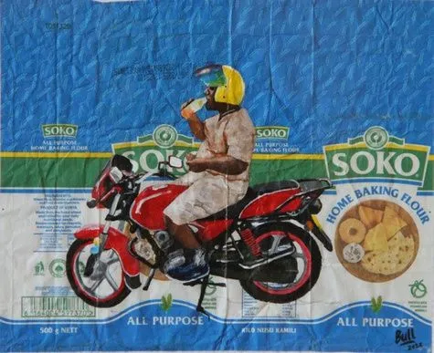 A rider in a pale jacket and yellow helmet on a red motorcycle, painted on blue Soko home baking flour packaging