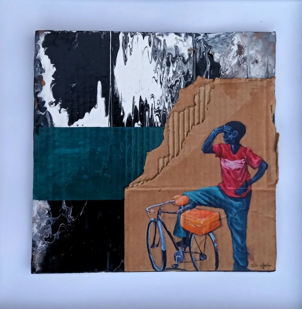 A young man in a red t-shirt shading his eyes, leaning against a bicycle with an orange box on the rack, on cardboard beside a teal band