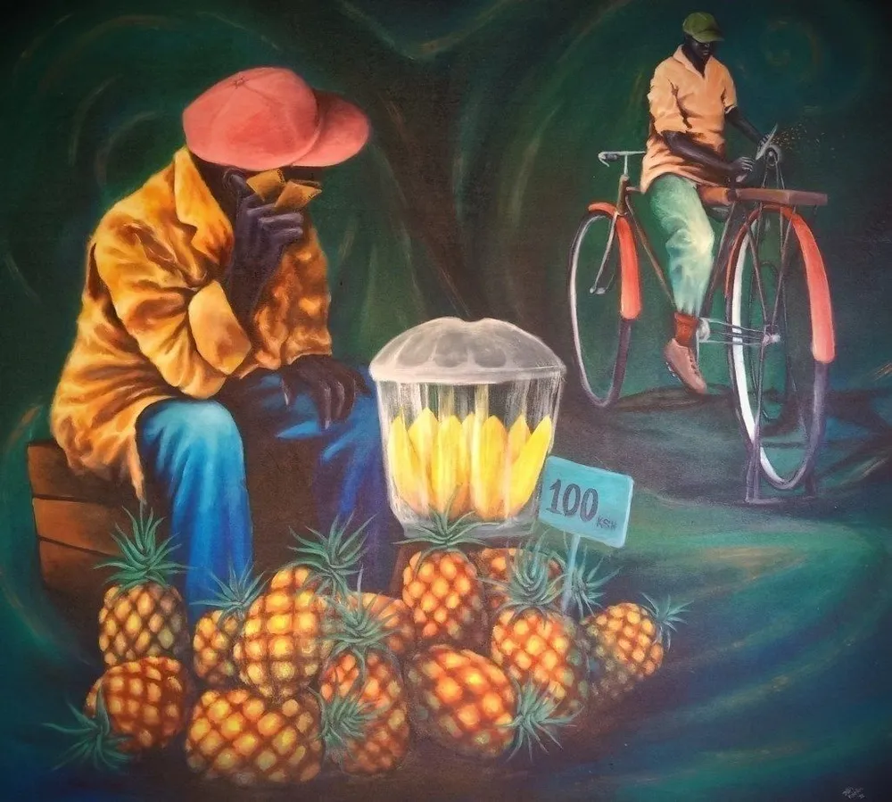 A fruit seller in an orange jacket and wide red hat sits behind a heap of pineapples and a covered jar of peeled fruit, a handwritten hundred shilling sign among them, a cyclist passing behind against a dark green ground